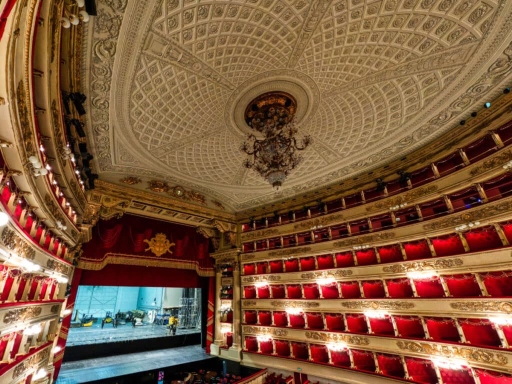 View of the intricate ceiling and the red interior of the La Scala