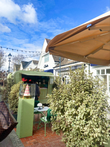 View of a Ladurée macaron cart outside among the outlets