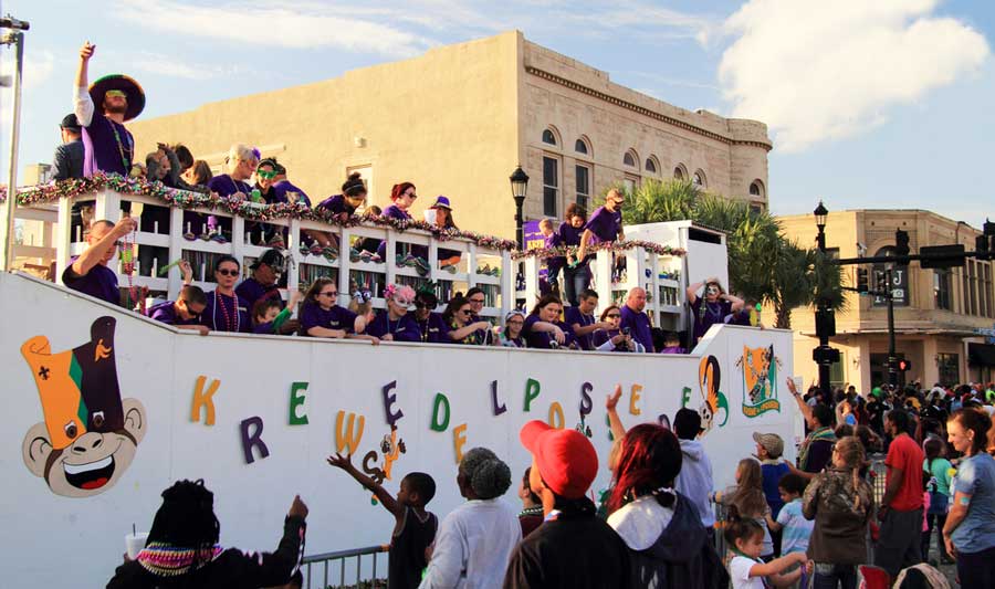 View of people celebrating on a parade during Lake Charles Mardi Gras