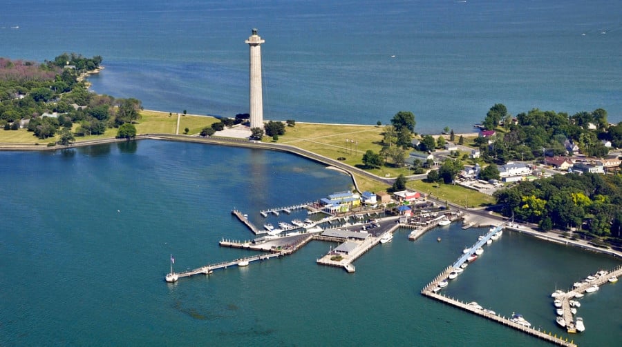 Aerial view of an island with a tall white lighthouse in South Bass island on Lake Erie