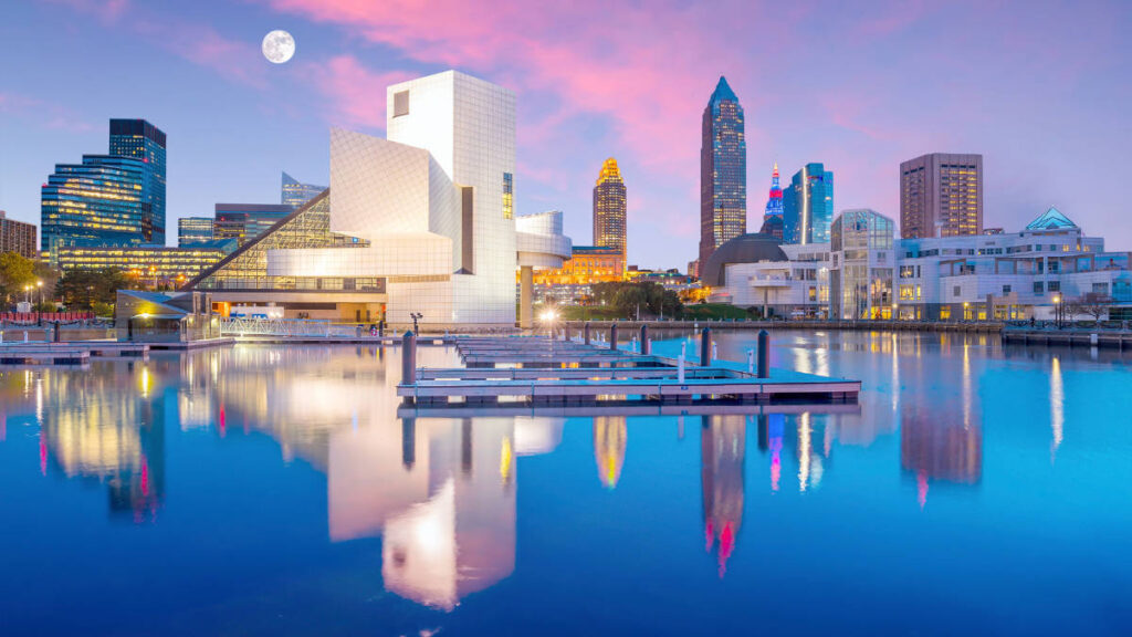 Colorful sky over the buildings and Lake Erie at Downtown Cleveland in Ohio during sunset