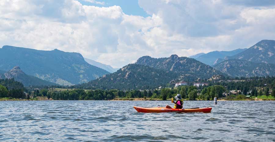 A woman kayaking in Lake Estes