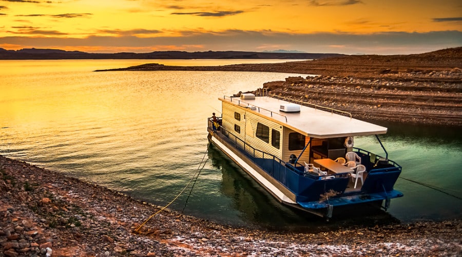 Scenic view of the sunset at Lake Mead with a houseboat moored to the shores of a bay