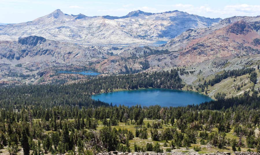Aerial view of a lake in the middle of the forest and mountain