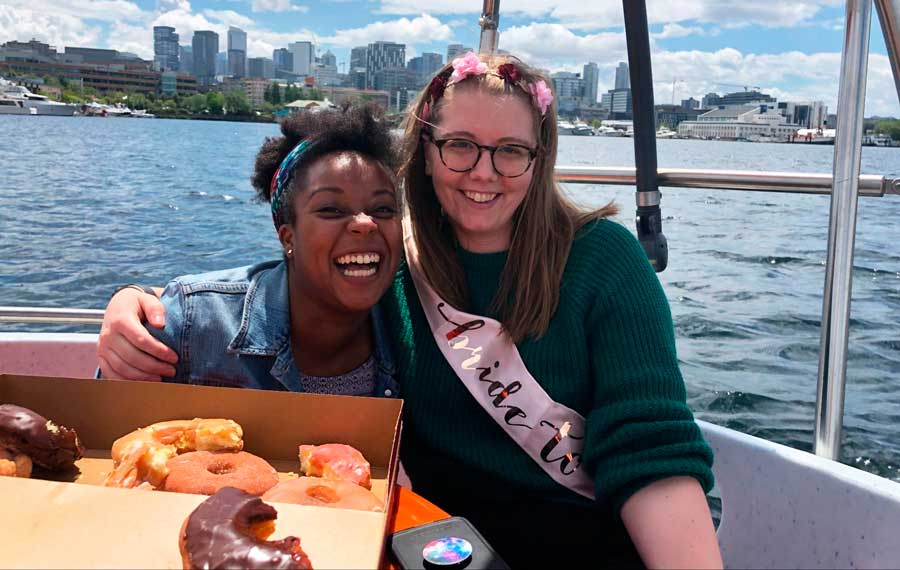 The author with her friend riding the Donut Boat with a box of donut