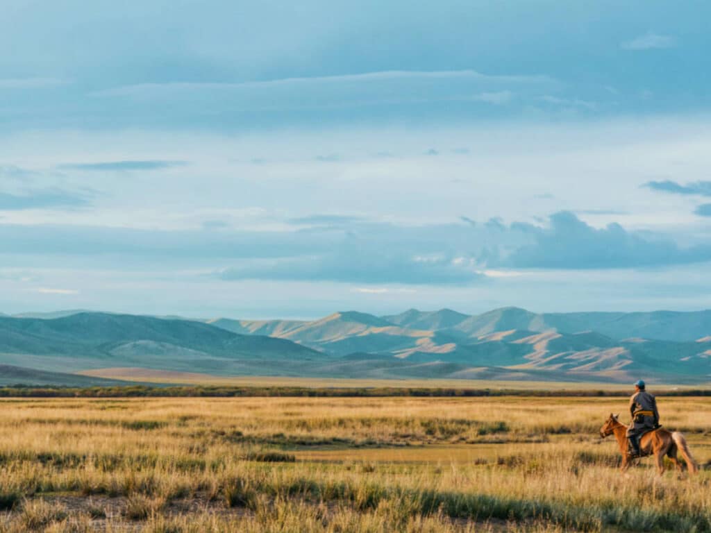A horse back rider wandering in Mongolia