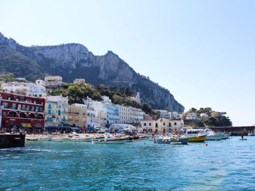 Picturesque view of the boats docked in front of the colorful buildings in Capri