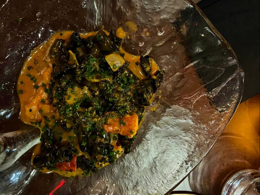 A closeup look at a vegetable soup on a glass bowl