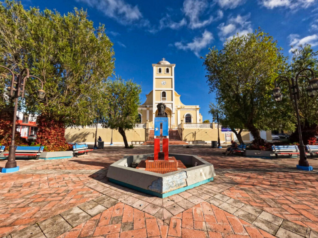 A sculpture in Lares’ Plaza with the church in the background