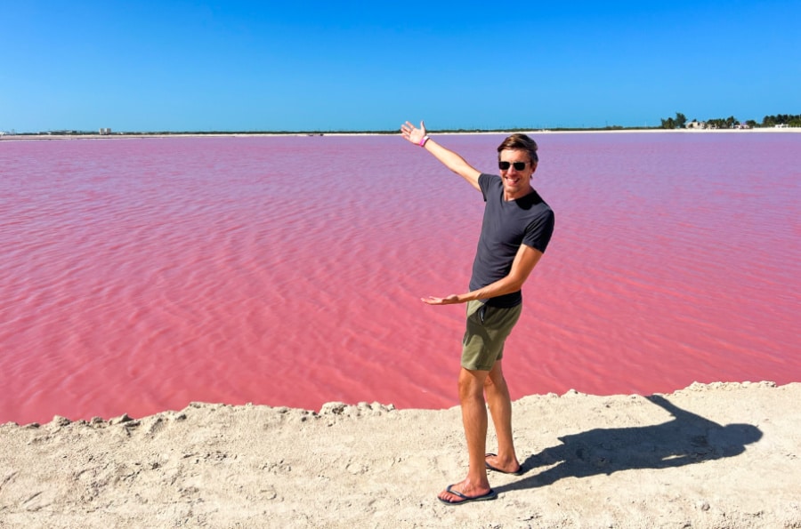 The author Nate Hake with arms outstretched at the Las Coloradas pink lakes 