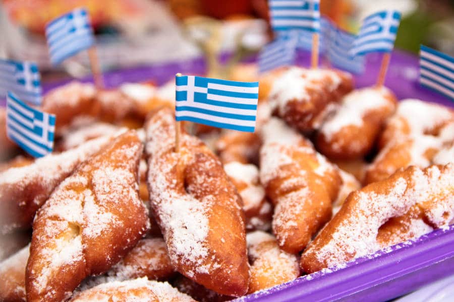 A closeup look at the pastries with sugar and Greek flags on top