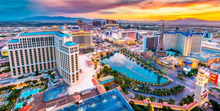 Aerial view of hotels in Las Vegas under the colorful sky during sunset