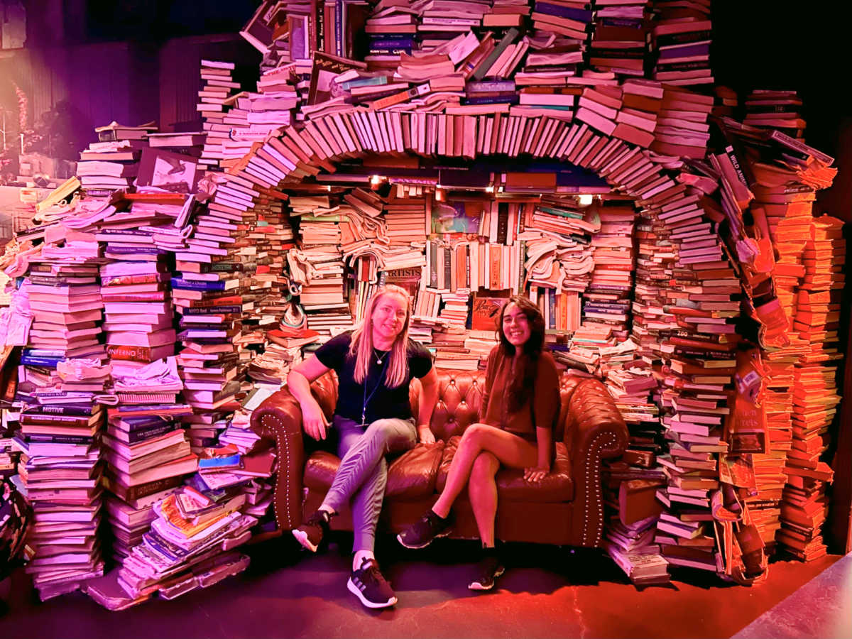 The author Laura Falin with Travel Lemming's editor, Abigail Bliss, posing inside the Meow Wolf Convergence Station