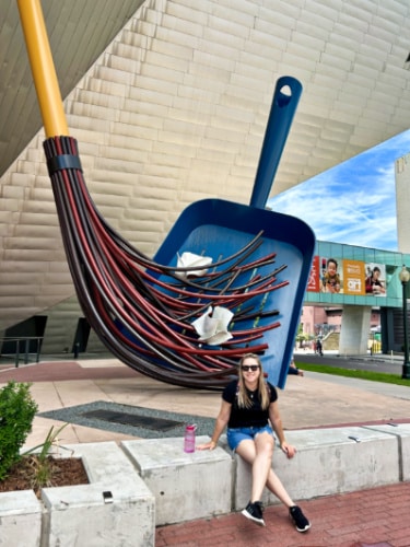 The author Laura Falin, posing near the cool sculpture outside the Denver Art Museum