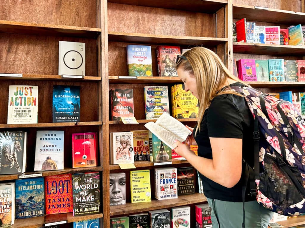 The author Laura Falin, reading a book inside the Tattered Cover Bookstore