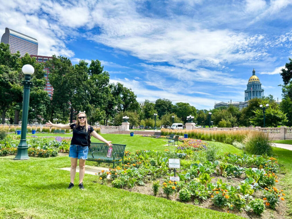 The author Laura Falin, posing at a park on a sunny day
