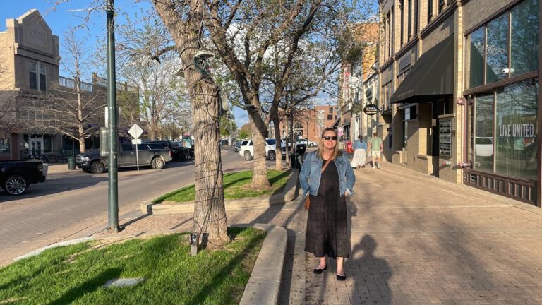 The author Laura Falin posing for a photo at the side of the street in Greeley