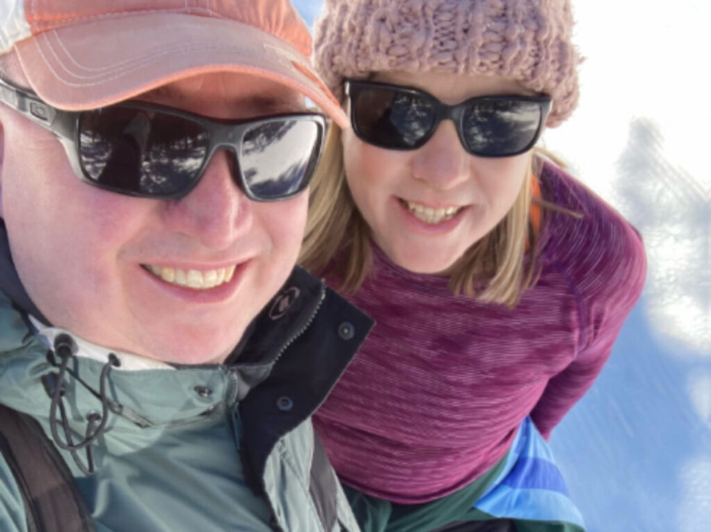 The author Laura Falin with her husband smiling for a selfie during winter season