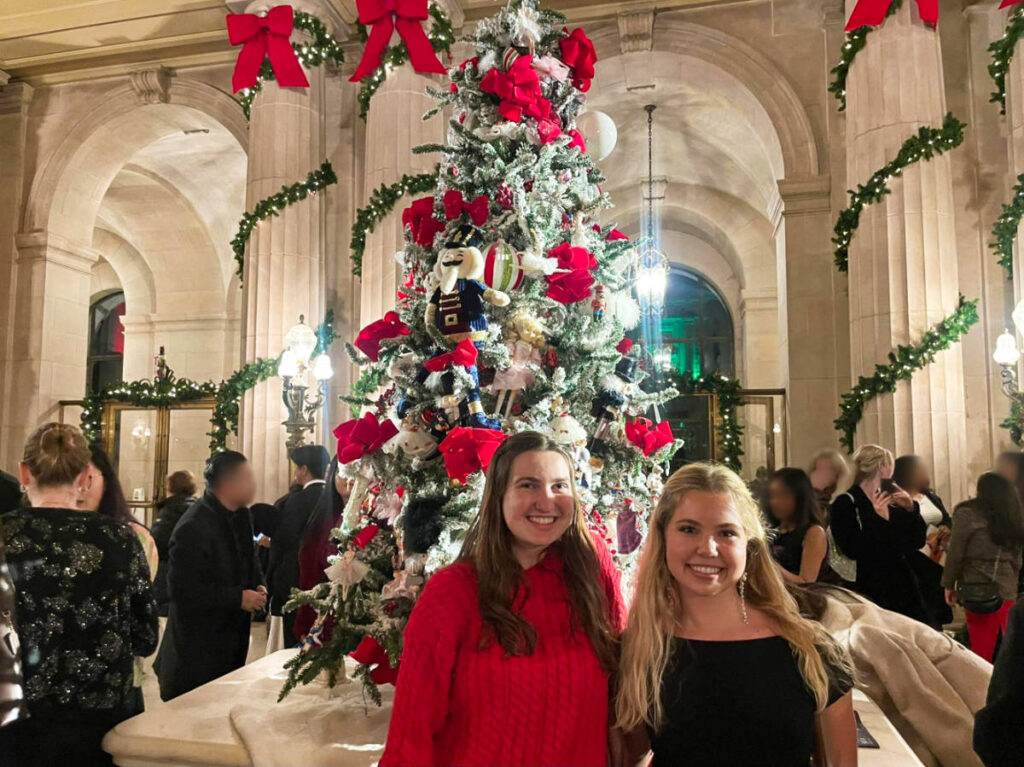 The author Laura and her cousin posing inside the SF Opera House with the Christmas tree behind