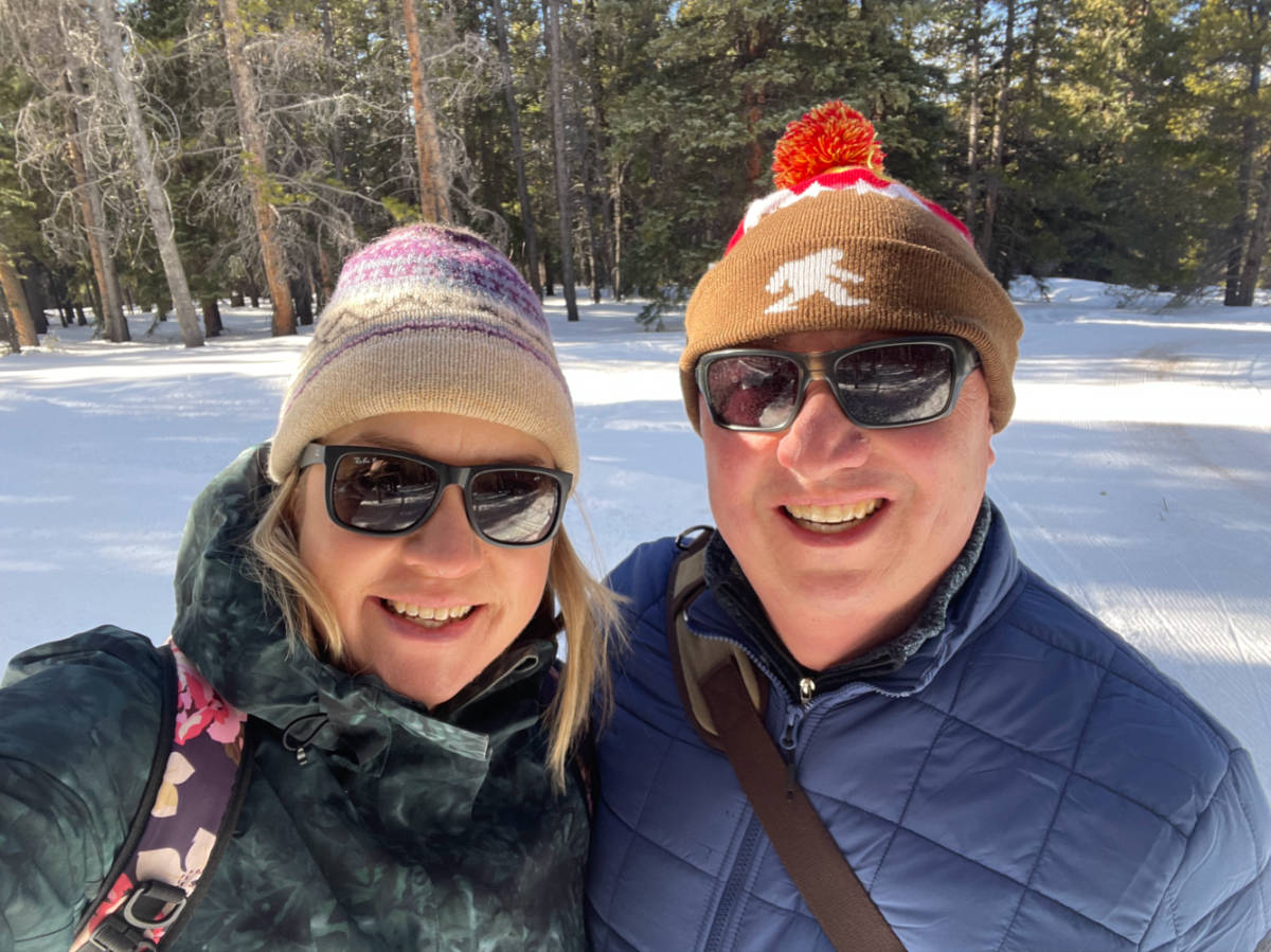 The author Laura Falin and her husband at Tennessee Pass surrounded by tall trees