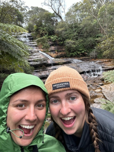 The author Laura McFarland and her partner wearing puffy jackets and beanies near the waterfalls