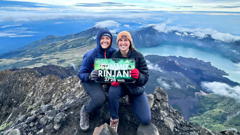 The author Laura McFarland and her partner posing for a photo on the summit of Mt. Rinjani