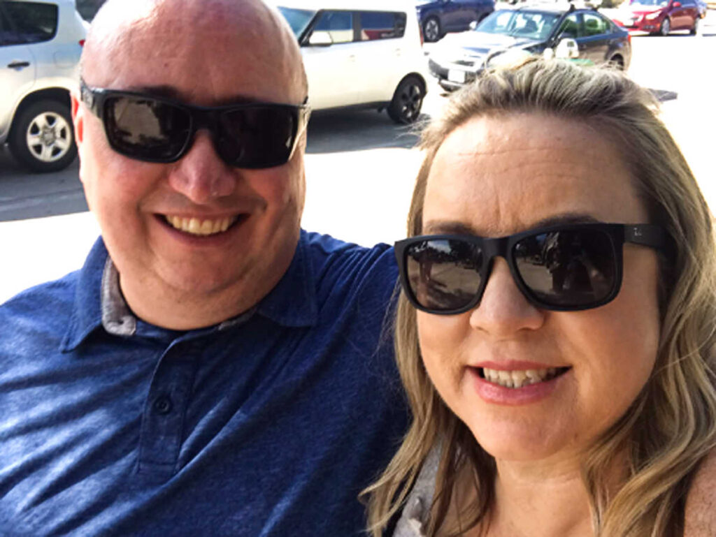 The author Laura Falin and her husband smiling for a photo
