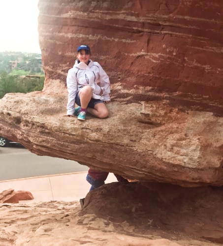 A girl posing on the Balanced Rock at Garden of the Gods