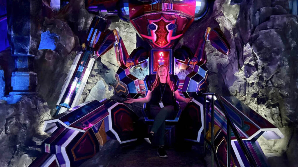 Travel Lemming writer and Denver local Laura Falin, sitting on a colorful throne at the Kaleidogothic Cathedral in Meow Wolf