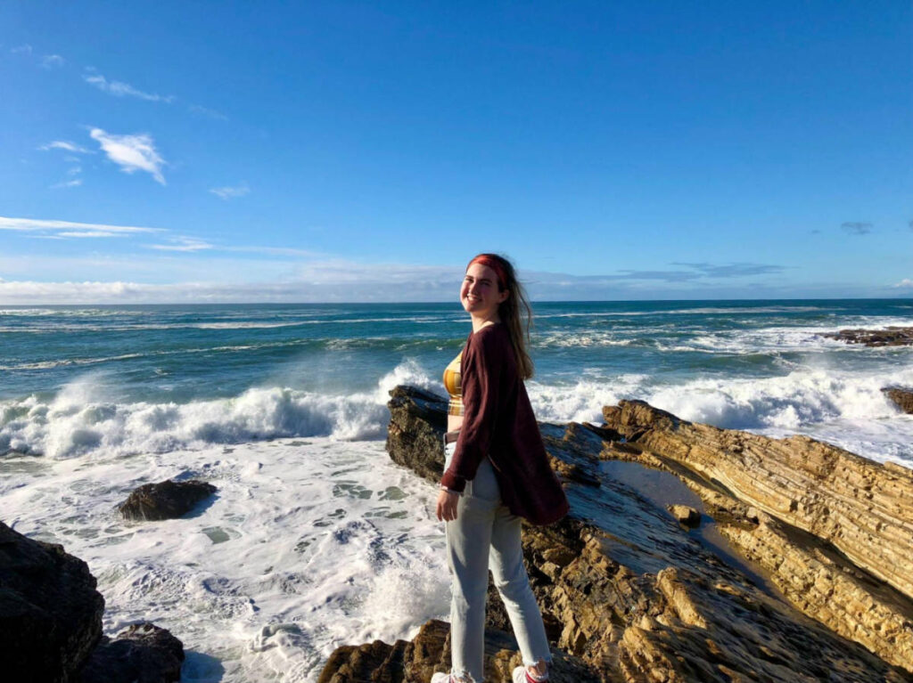 The author Laura McFarland posing for a photo on the rocky beaches of Montaña de Oro