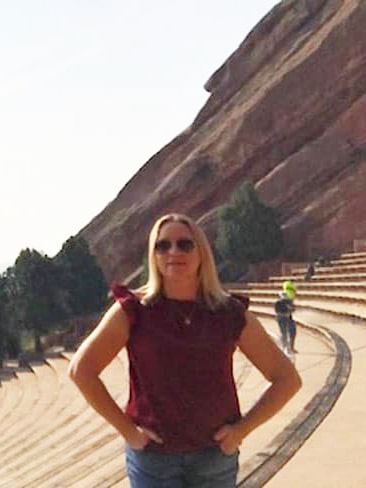 Laura Falin smiling for a photo at the Red Rocks Park and Amphitheatre