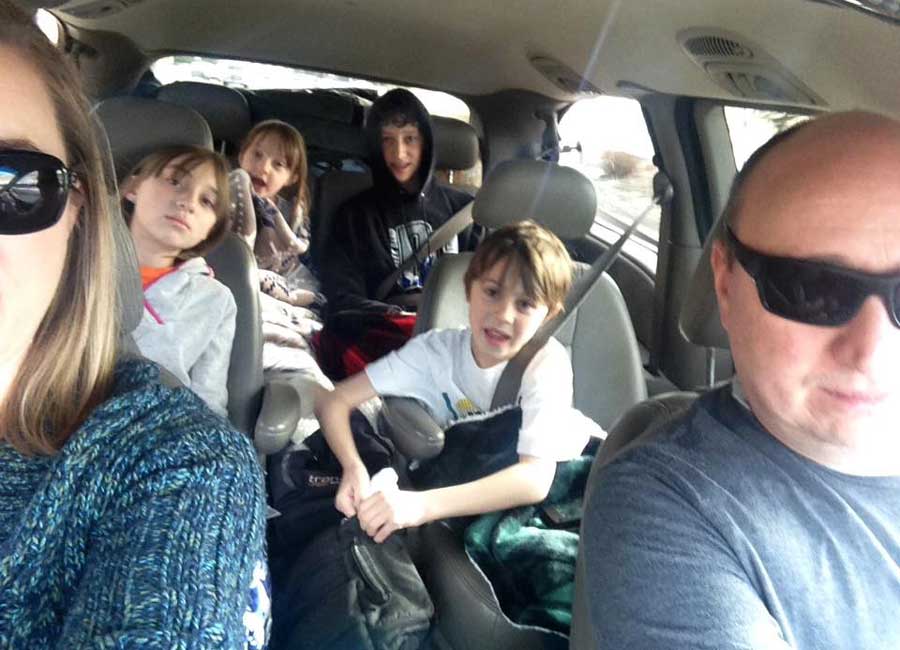 The author with her whole family getting ready for a photo inside their car