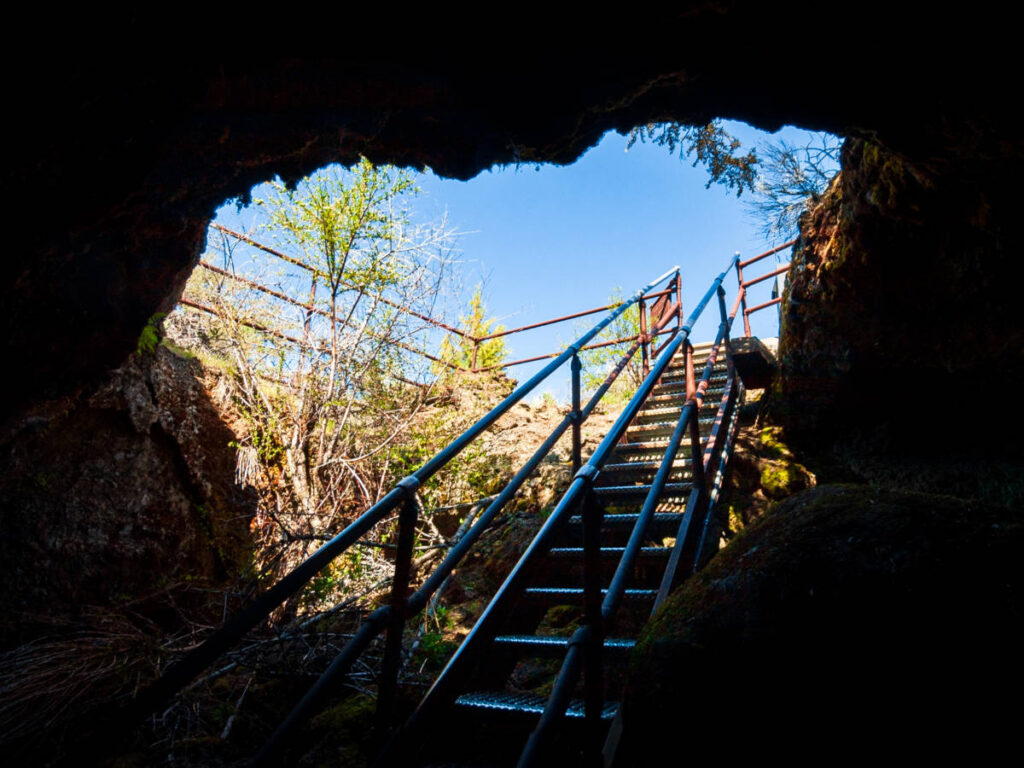 View of the opening of the cave from below the ground in Lava Beds National Monument