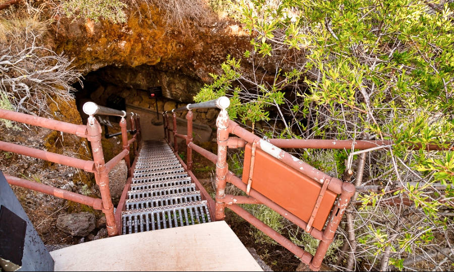 View at the entrance with a metal staircase of underground lava tube caves