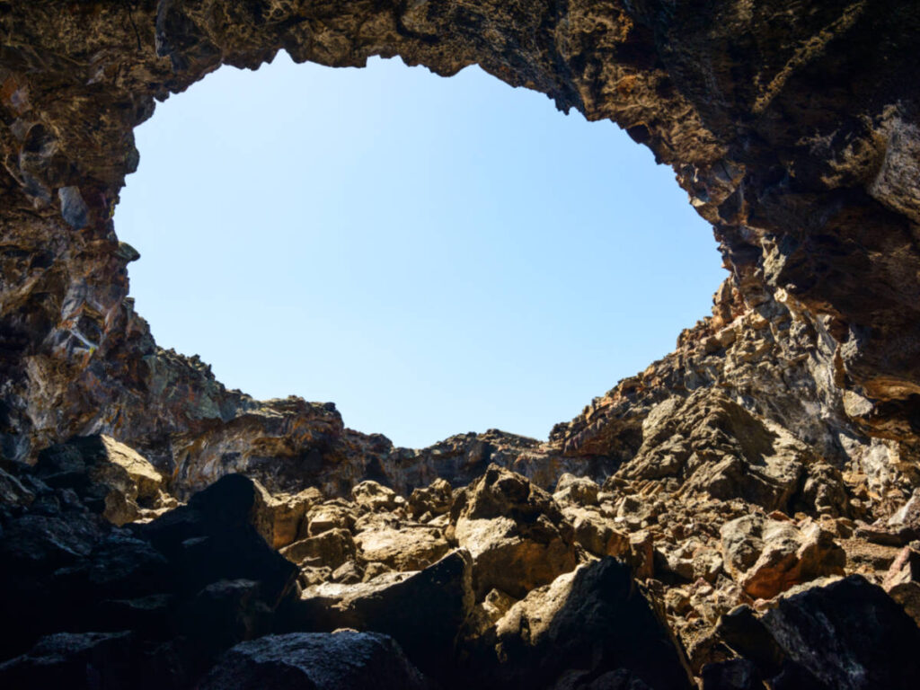 The lava tubes opening with clear blue sky view from the inside