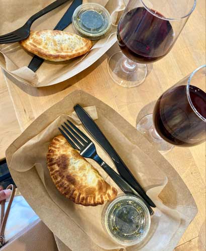 Empanadas and two glasses of Malbec wine in Lazo Empanadas