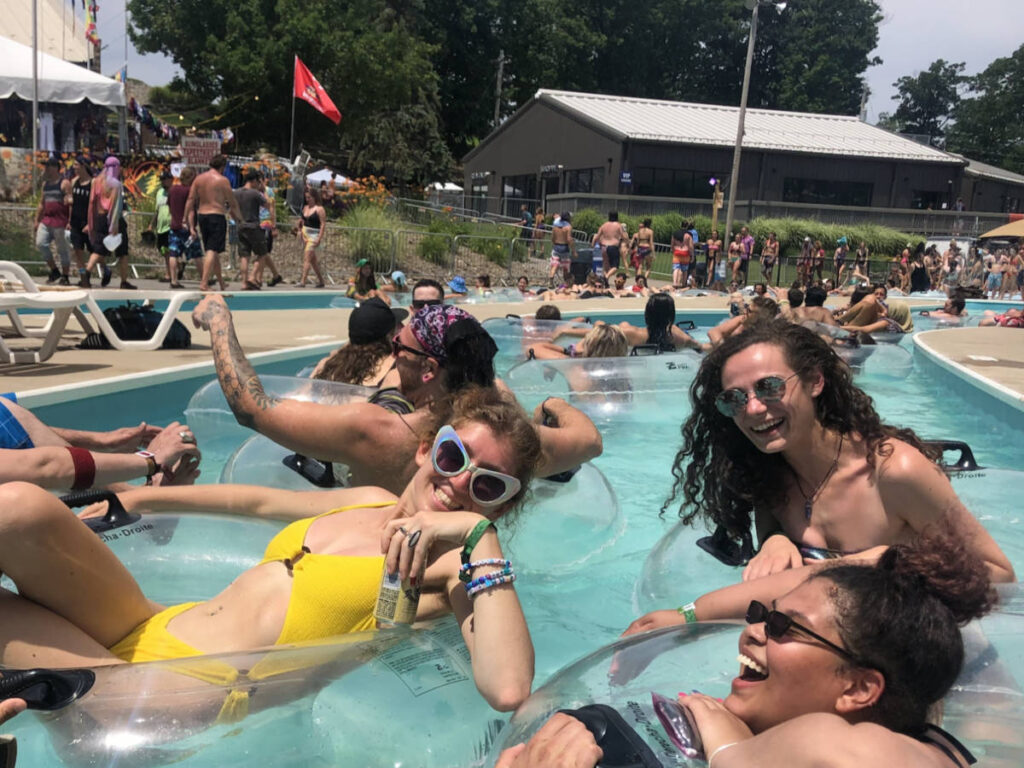 Group of friends enjoying while floating in the lazy river at Camp Bisco