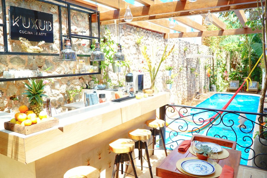 Outdoor dining near the pool at Le Muuch Hotel Valladolid