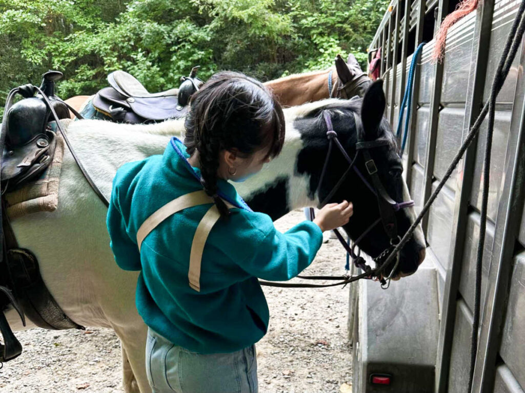 The author Lea Rose petting a horse
