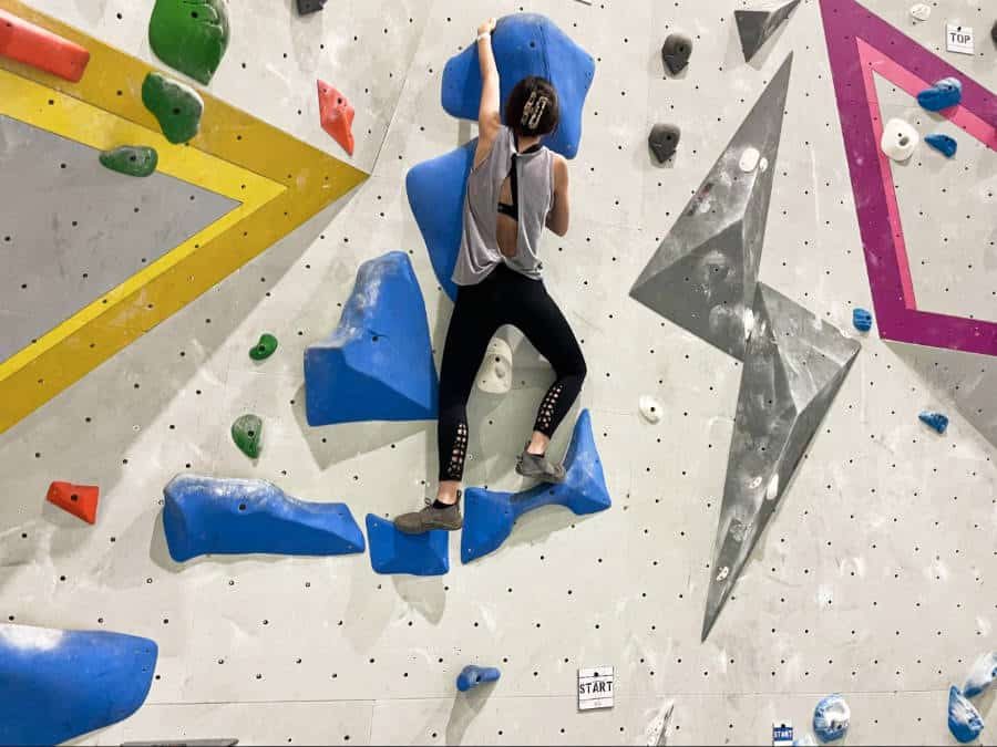 The author Lea Rose rock climbing at the Riveter in Mills River