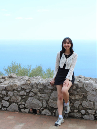 The author, Lea Rose Allbaugh wearing a dress with her Salomon xt6 trail runners