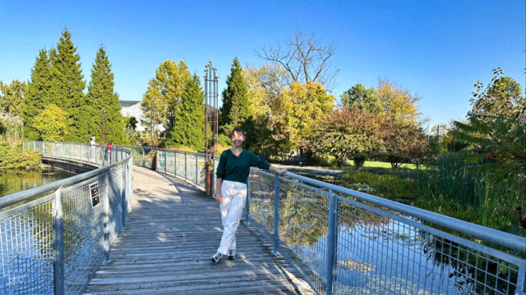 The author Lea Rose posing for a photo on the bridge at Garfield Park Conservatory