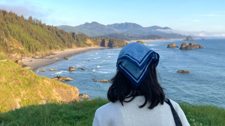 Travel Lemming editor Lea Rose overlooking Cannon Beach at Ecola State Park in Oregon