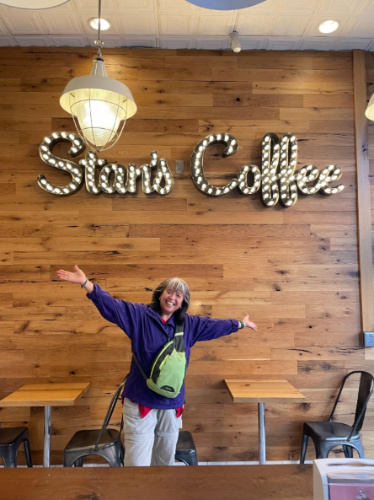 The author's mom posing for a photo inside the Stan’s Donuts