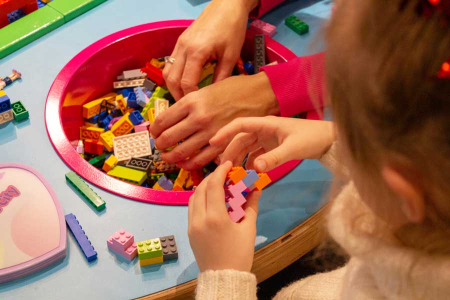 A kid playing legos at the Legoland Discovery Center