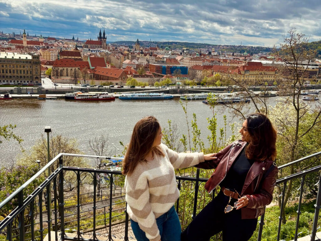 Author Meera and her friend enjoying the views from Letna Beer Garden
