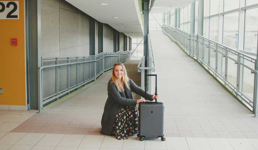 The author holding her Level8 Textured Carry On Luggage