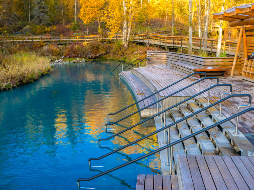 A serene view of Liard Hot Springs, with crystal-clear turquoise water