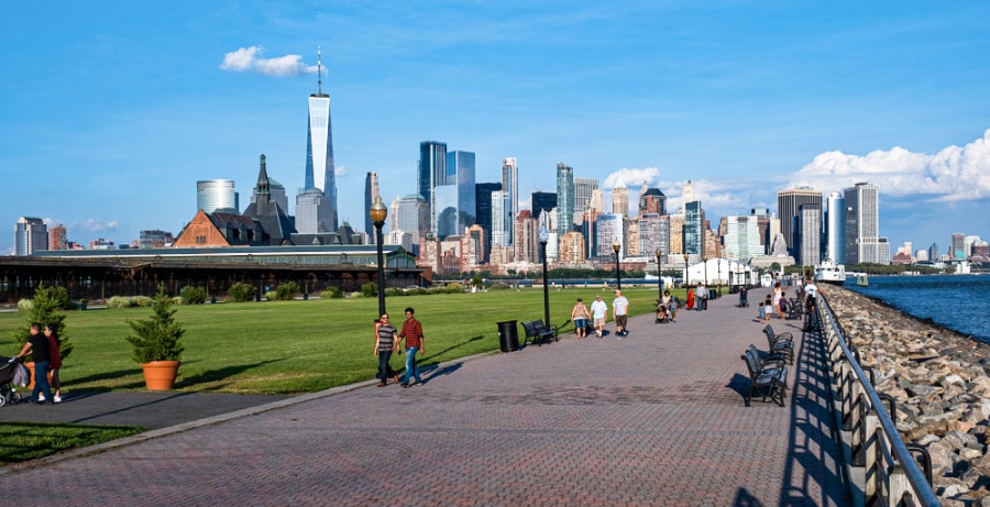 People walking around the Liberty State Park with a cityscape and ocean views