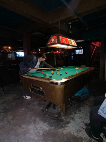 A man playing pool at the basement of Life of Riley